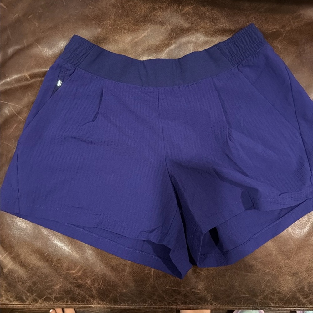 Purple Athleta textured Brooklyn shorts w an elastic waistband and zip pockets